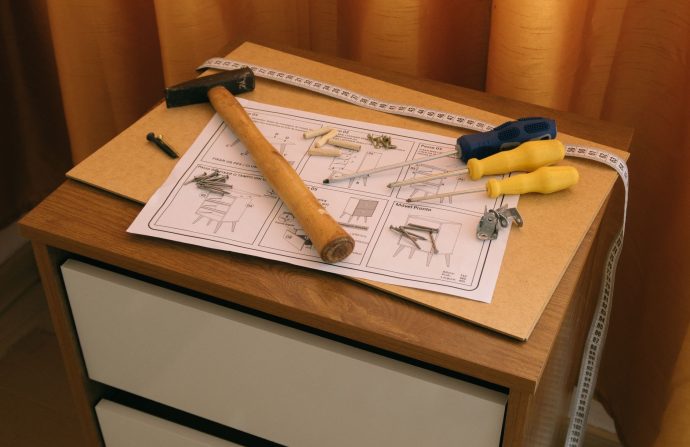 From above of wooden cabinet with drawers and paper instruction with tool to assemble it — 6 Ways to Meet Single Men