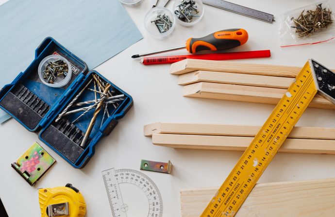 A top view of various woodworking tools and materials on a white table. — A Big Entertainment by Outdoor Furniture