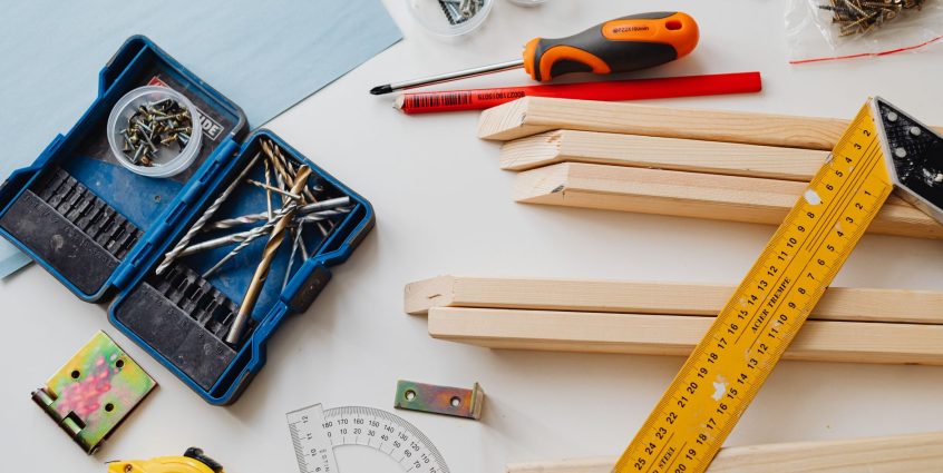 A top view of various woodworking tools and materials on a white table. — A Big Entertainment by Outdoor Furniture