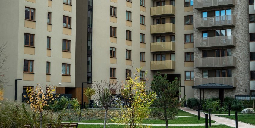 Contemporary high-rise apartment buildings with lush greenery and pathways in the courtyard. — Basics of Asbestos