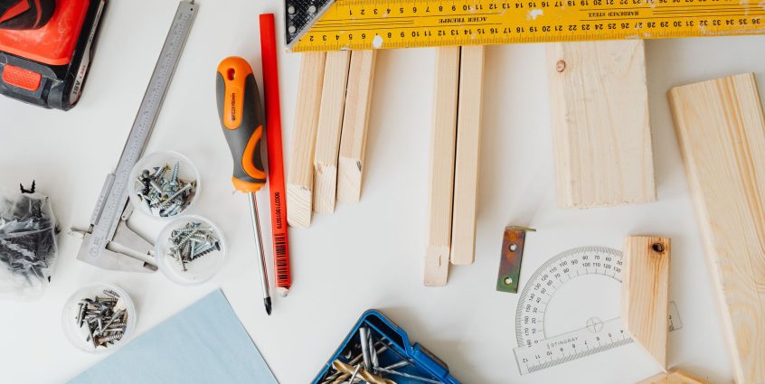 Top view of carpentry tools and wooden planks neatly arranged for a project. — Expert Antivirus Products