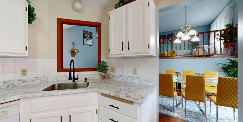 Bright modern kitchen with marble countertops overlooking a stylish dining area. — Features to Look For in Board Webpages Sof