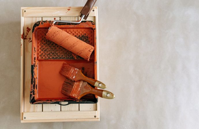 An overhead shot of paintbrushes and a roller in a tray, perfect for home renovation projects. — Leading Antivirus Service pl