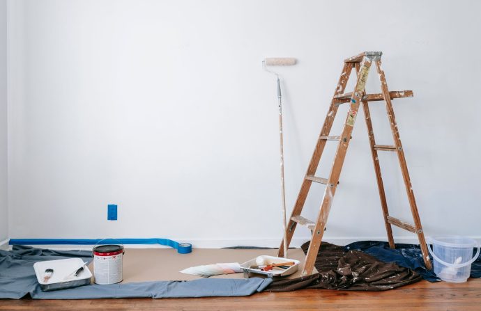 A room prepared for renovation with a ladder, paint supplies, and drop cloth. — Malware Review -- How to Choose the very best