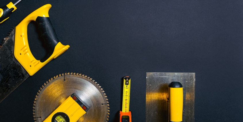 Hand tools arranged on a black surface, featuring saws, levels — Pickup Lines That Actually Work On Women