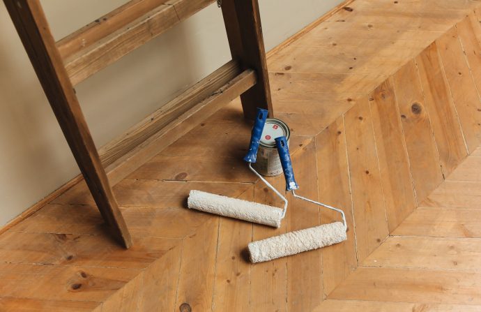 Paint rollers and ladder on a wooden floor, perfect for DIY renovation projects. — Precisely what is Eco Design?