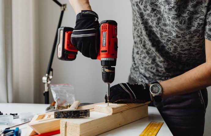 A skilled craftsman working on a wooden piece using a power drill, showcasing precision and expertise. — The biggest launch o