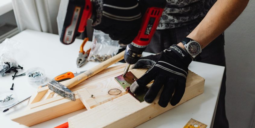 A craftsman uses a power drill on wood, showcasing carpentry tools and skills. — The Solitary Population Is Actually Booming