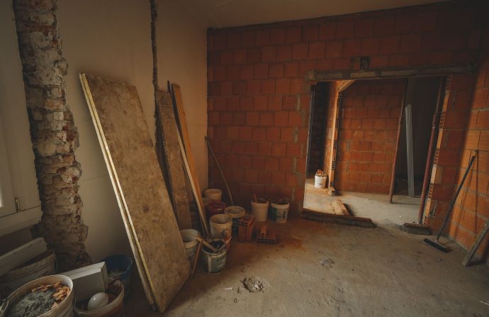 A red brick wall under construction with tools and materials scattered around in a renovation project. — The very best Free V