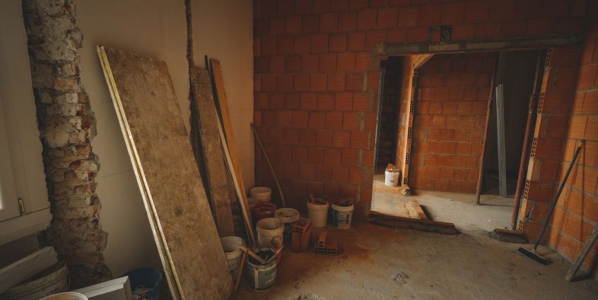 A red brick wall under construction with tools and materials scattered around in a renovation project. — The very best Free V