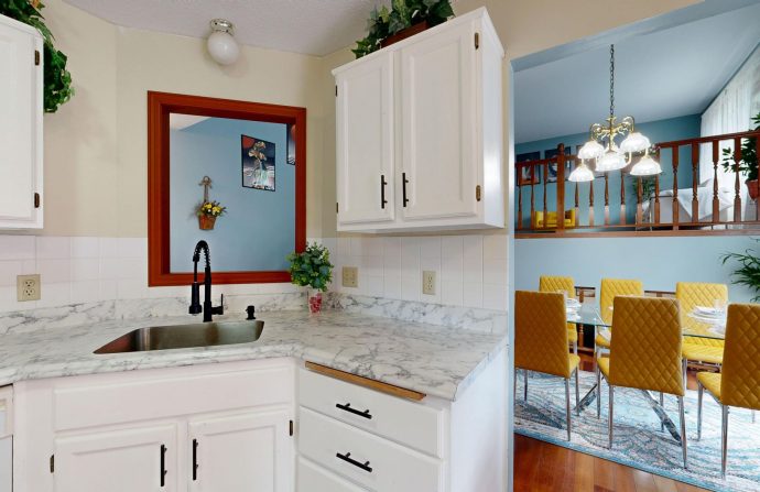 Bright modern kitchen with marble countertops overlooking a stylish dining area. — Using a VPN For Free